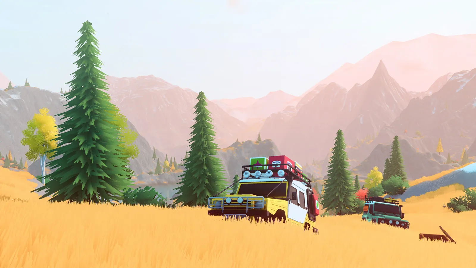 Three vehicles travelling together through a mountain meadow.